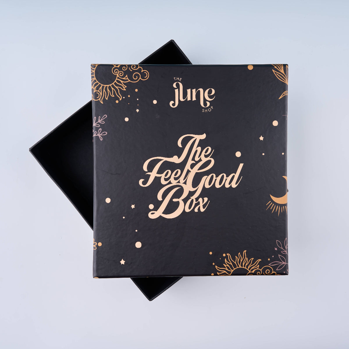 Black box with 'The Feel Good Box' text and decorative patterns on a light blue background
